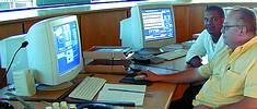 The control room at Faure Water Treatment Plant: in the foreground is Eric Bezuidenhout, the acting manager of the Faure Water Treatment Plant and behind him is one of the process controllers, Willem de Kok